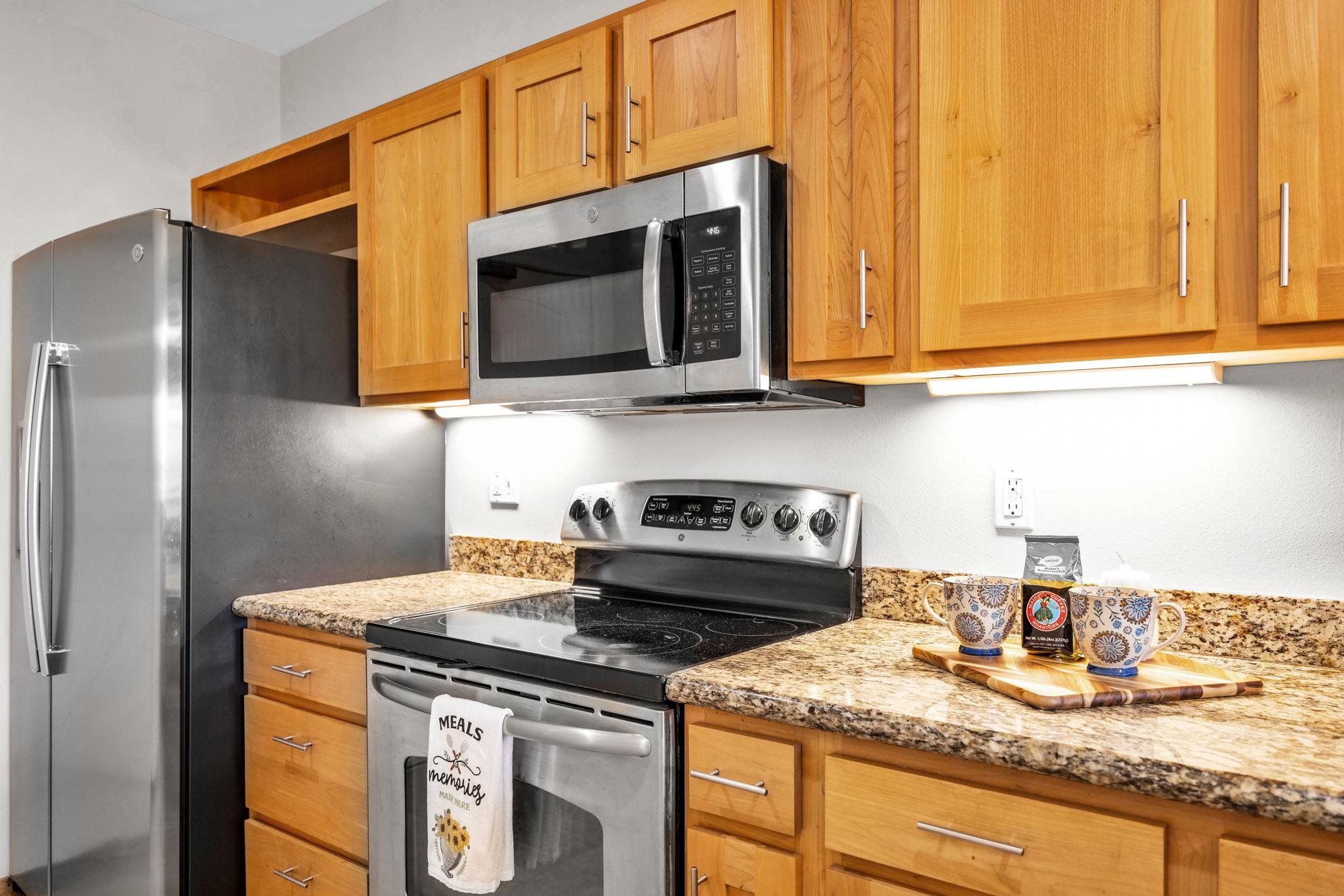 3708 Lower Honoapiilani Road, Unit E33 Lahaina, HI 96761 - Photo 4 of 36 a kitchen with granite countertop a sink stove and microwave