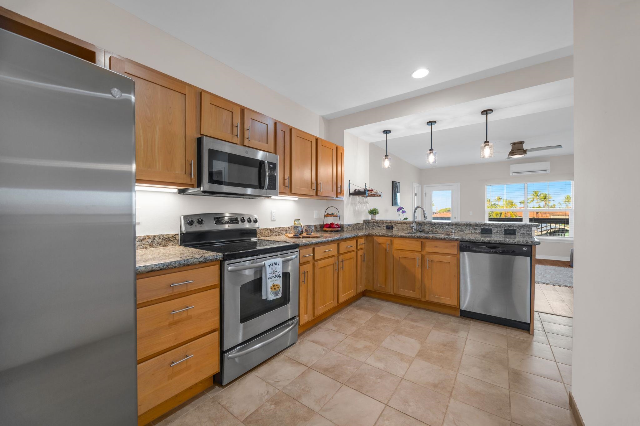 3708 Lower Honoapiilani Road, Unit E33 Lahaina, HI 96761 - Photo 5 of 36 a kitchen with a sink cabinets and stainless steel appliances
