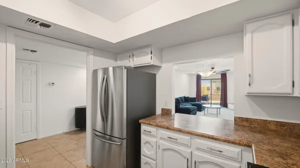 a kitchen with stainless steel appliances granite countertop a refrigerator and a sink