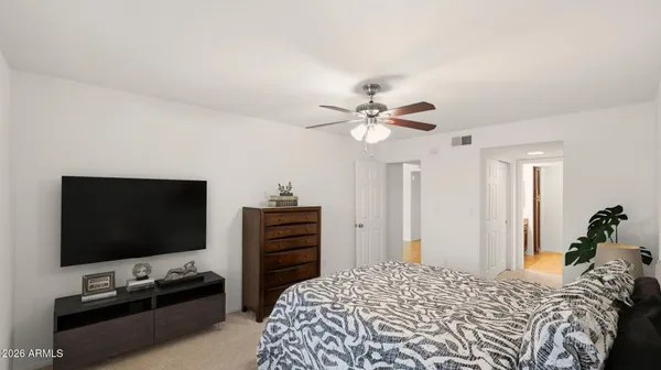 a bedroom with a bed and a flat screen tv