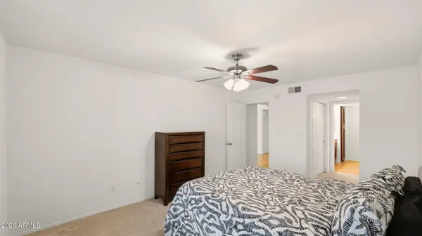 a bedroom with a bed and a chandelier