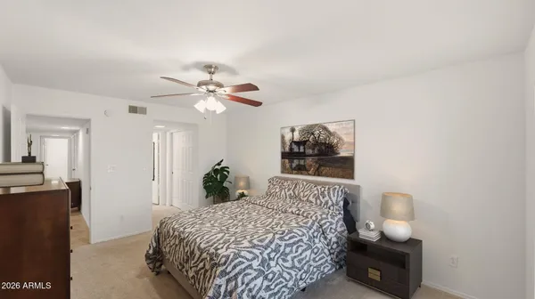 a bedroom with a bed and a lamp with window