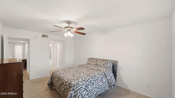 a bedroom with a bed and a chandelier