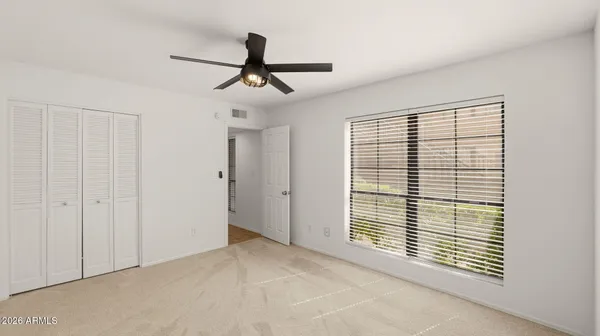 a view of a livingroom with a ceiling fan and window