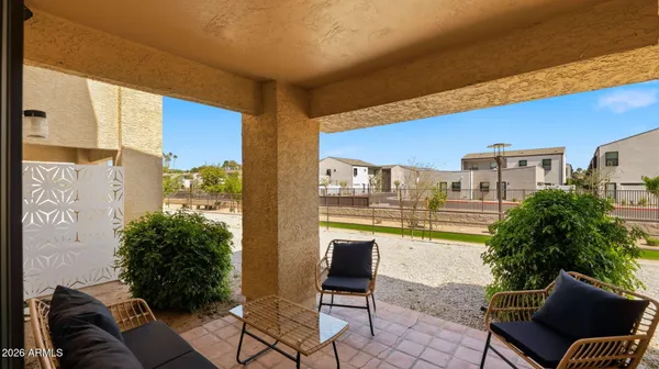 a living room with furniture and a floor to ceiling window