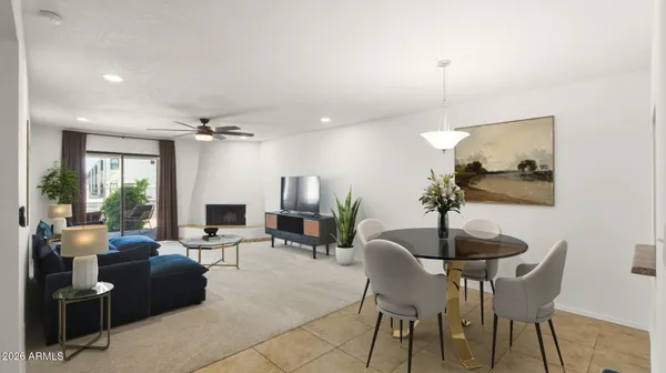 a living room with furniture kitchen view and a large window