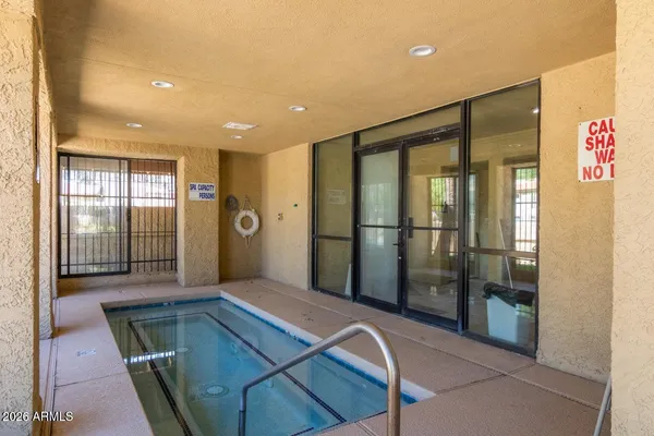 a room with pool table and windows