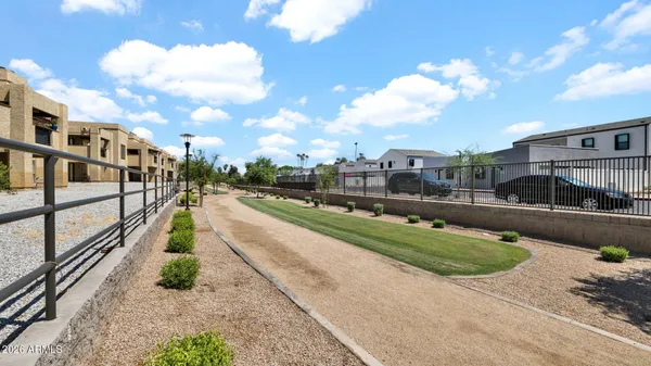 a view of a street with a building and a street sign