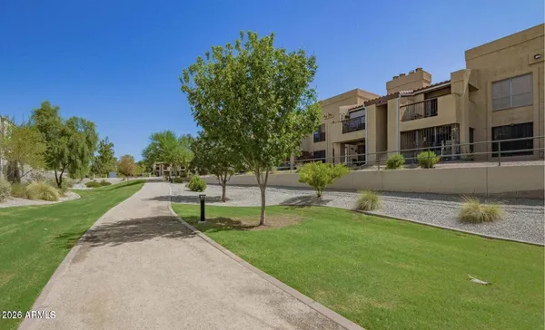 a view of a swimming pool with a bench and lawn chairs