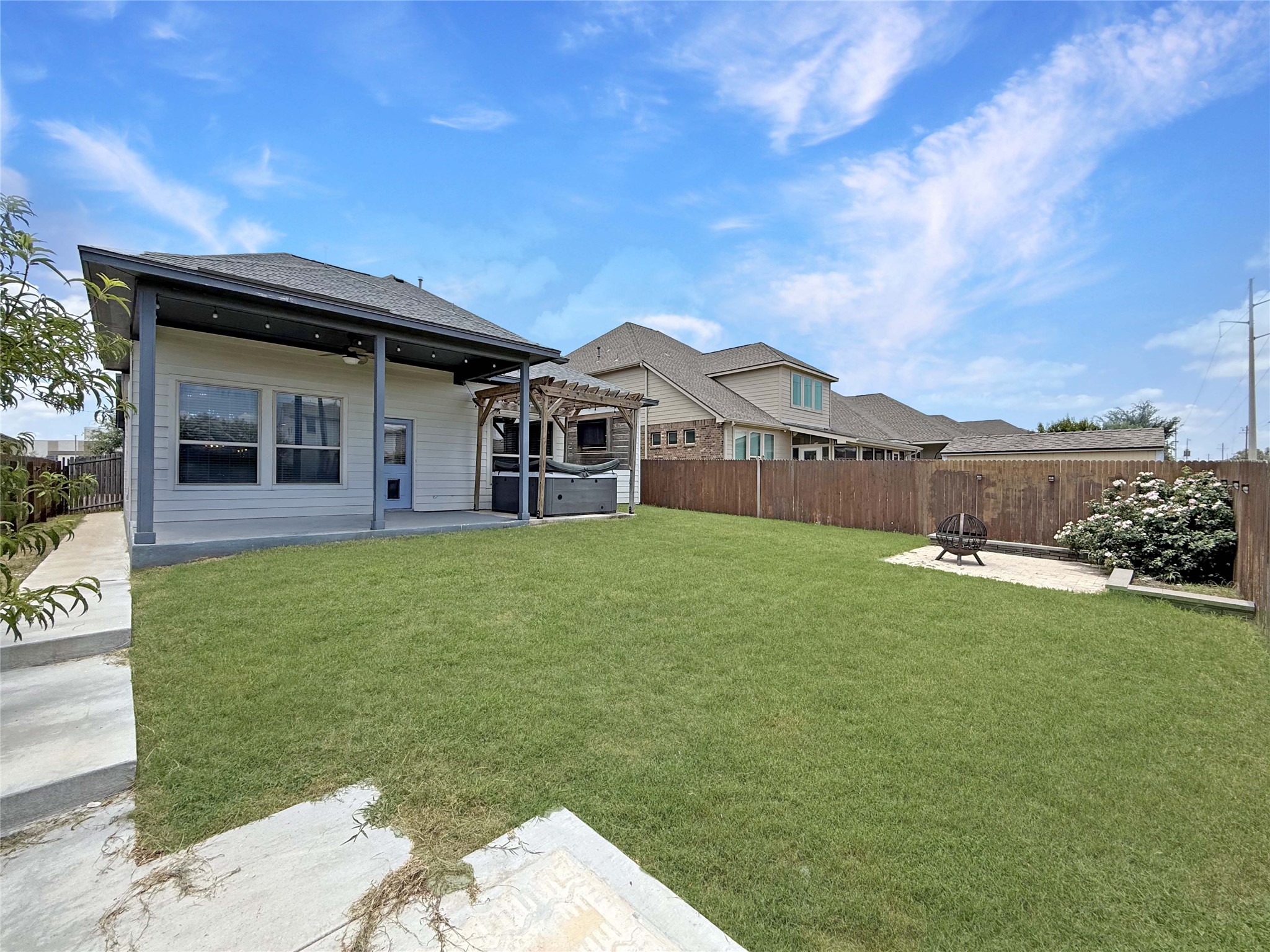 429 Rusk Bluff Avenue Leander, TX 78641 - Photo 22 of 24 A generous backyard features a covered patio, a wooden pergola, and ample green space for outdoor leisure.