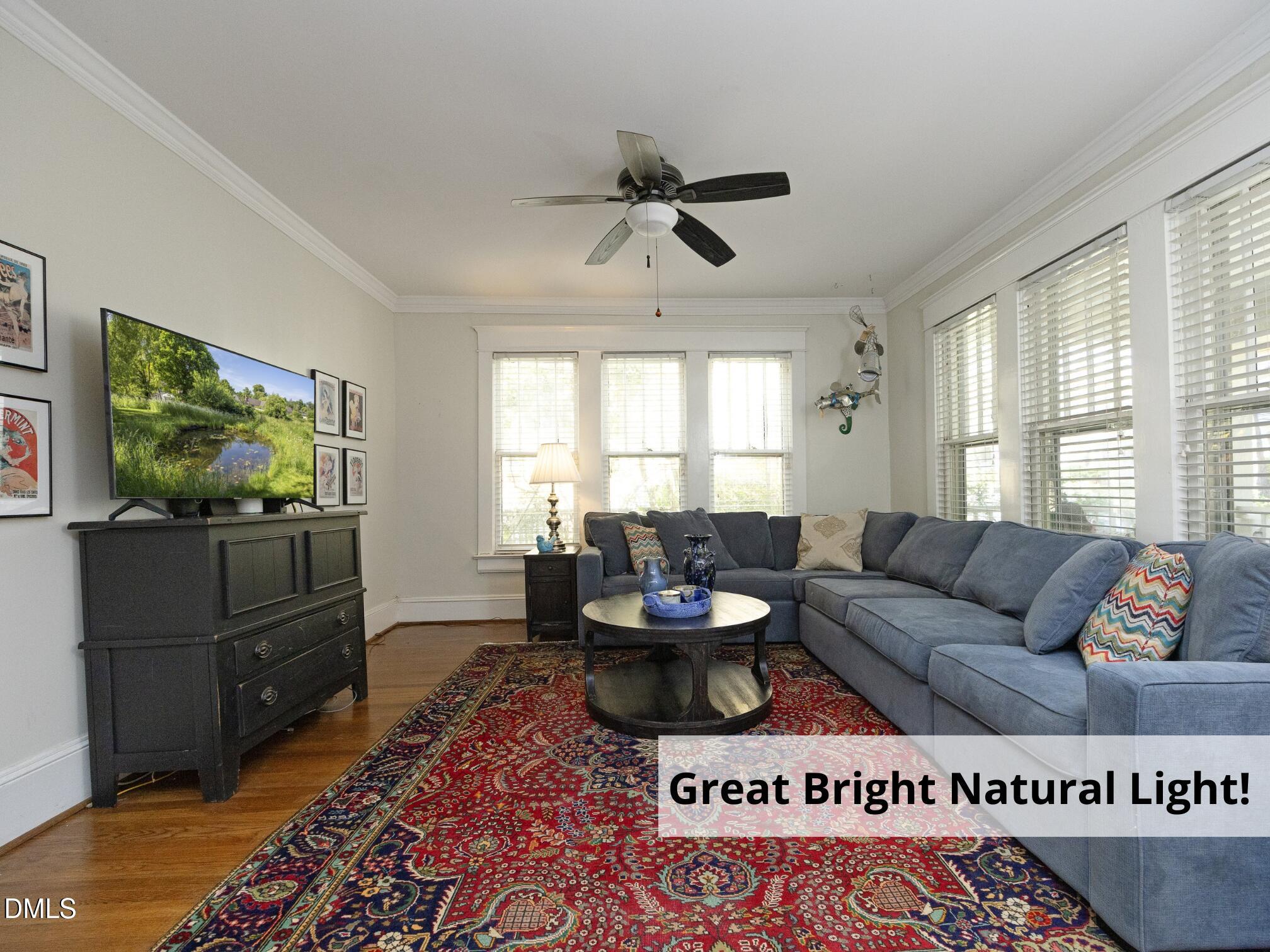 825 Onslow Street Durham, NC 27705 - Photo 14 of 71 a living room with furniture a flat screen tv and a large window