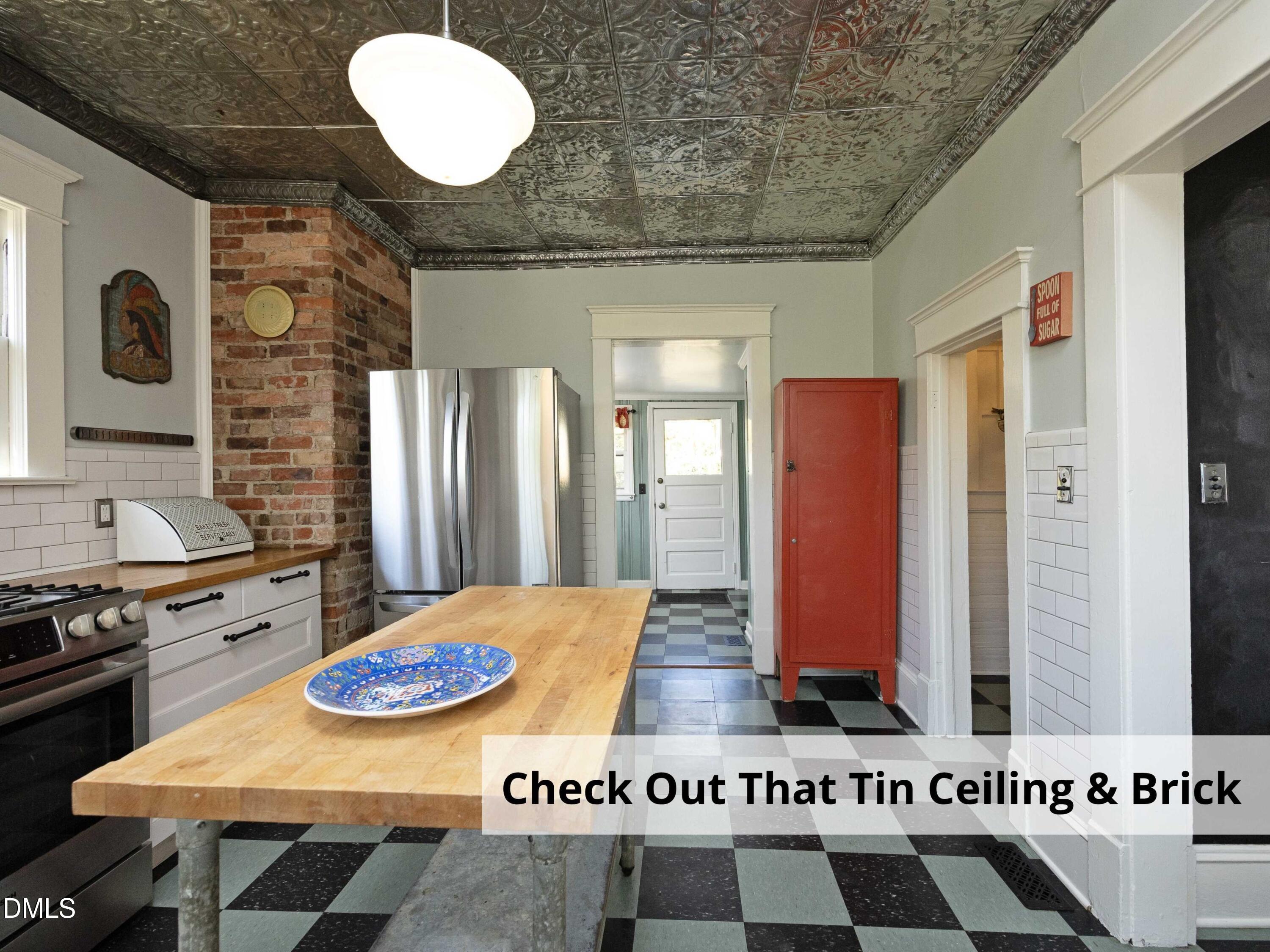 825 Onslow Street Durham, NC 27705 - Photo 28 of 71 a kitchen with stainless steel appliances granite countertop a stove and a refrigerator