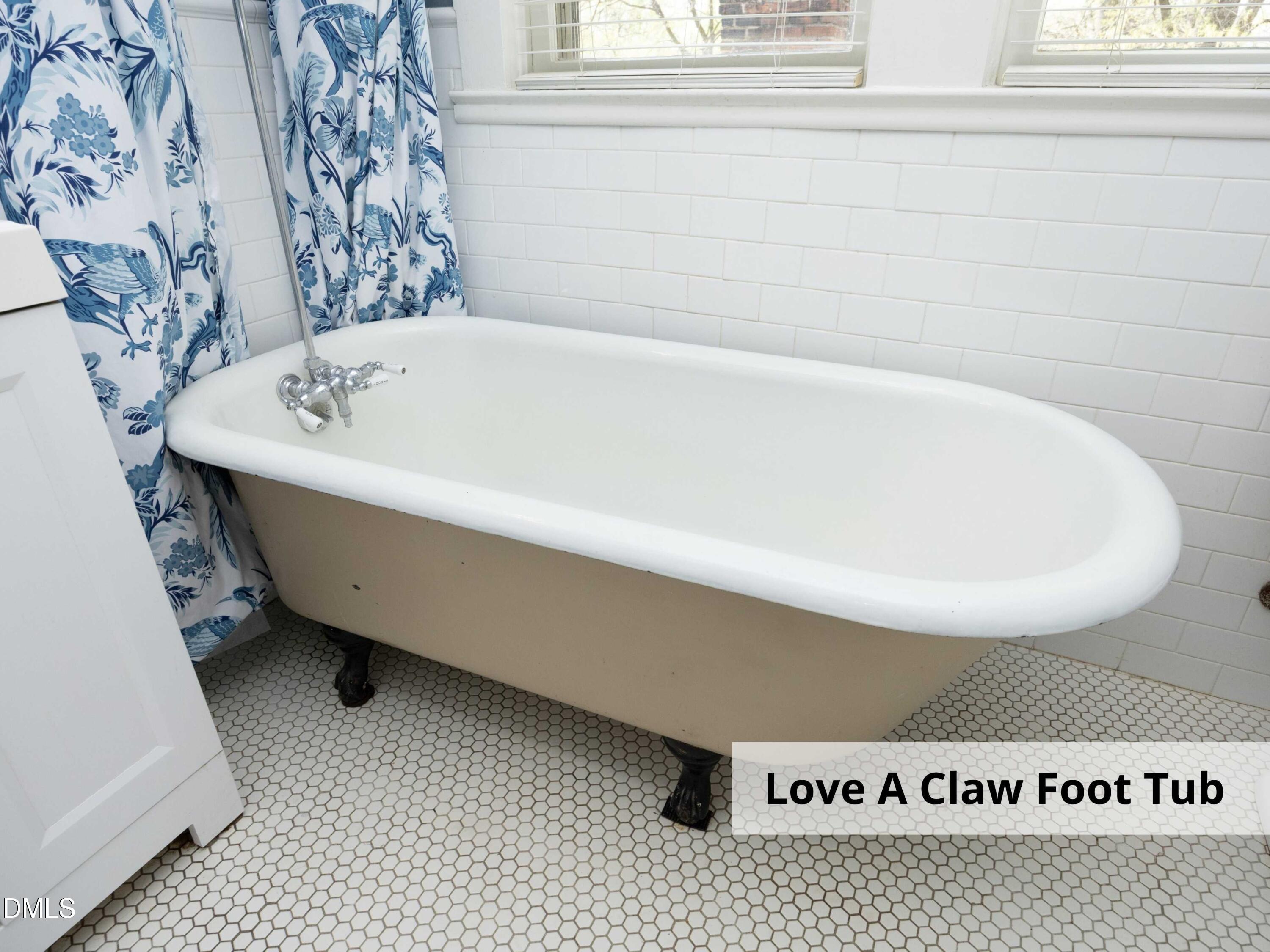 825 Onslow Street Durham, NC 27705 - Photo 44 of 71 a bath tub sitting next to a white sink and a toilet