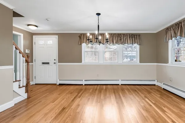 a view of a room with wooden floor