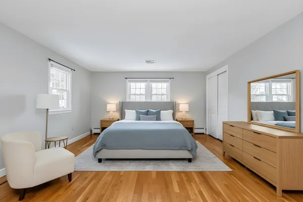 a spacious bedroom with a bed and window