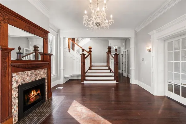 a view of a livingroom with wooden floor and a fireplace