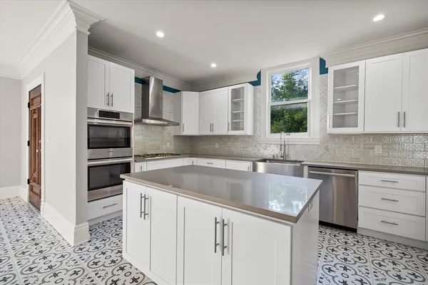 a kitchen with a sink stove and microwave