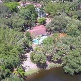 an aerial view of a house with a yard and lake view
