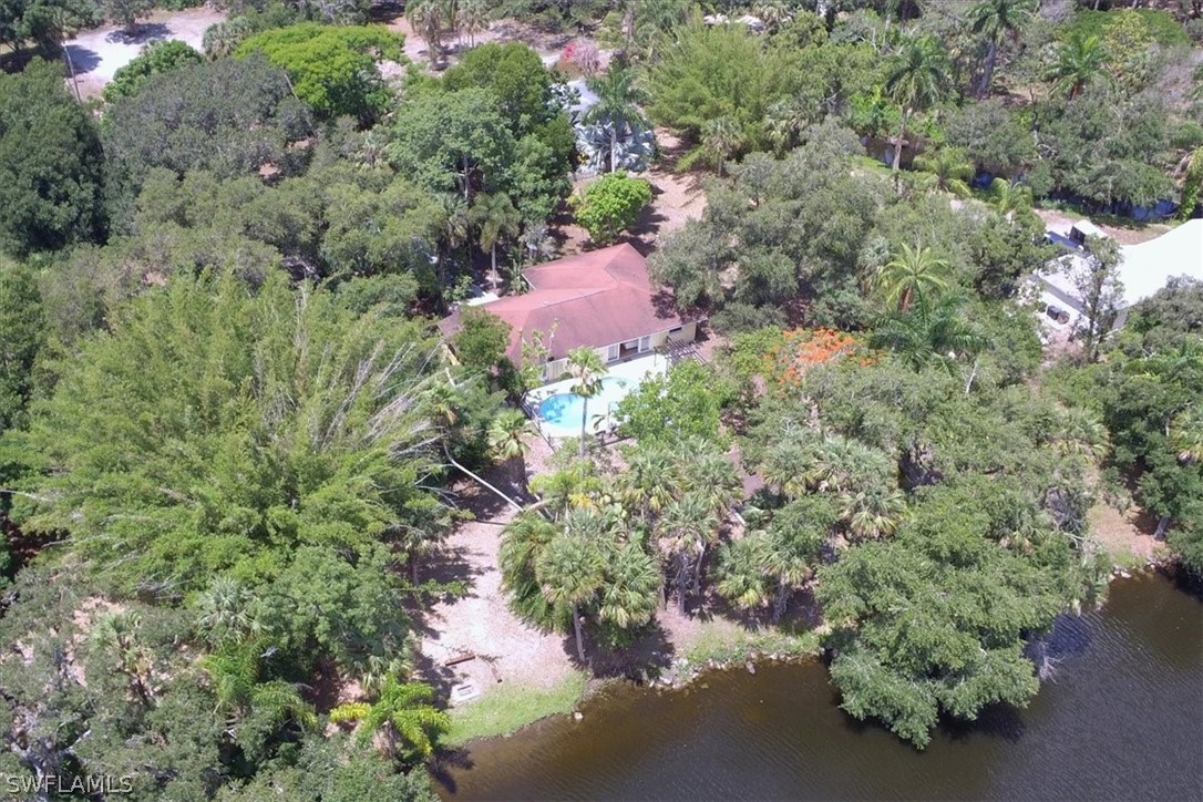 12271 Coyle Road Fort Myers, FL 33905 - Photo 1 of 33 an aerial view of a house with a yard and lake view
