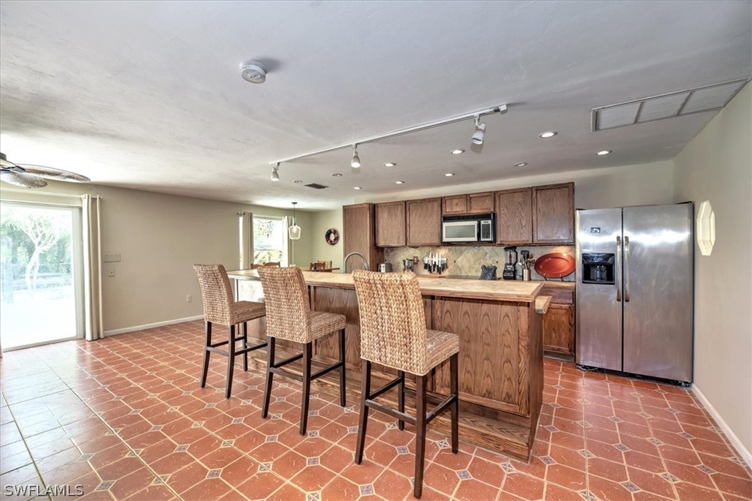 12271 Coyle Road Fort Myers, FL 33905 - Photo 11 of 33 a kitchen with a dining table chairs and large window