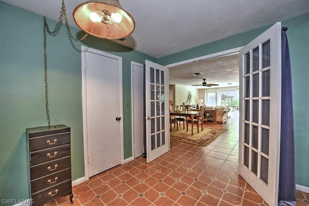 12271 Coyle Road Fort Myers, FL 33905 - Photo 15 of 33 a view of a room with lots of wooden furniture and a chandelier