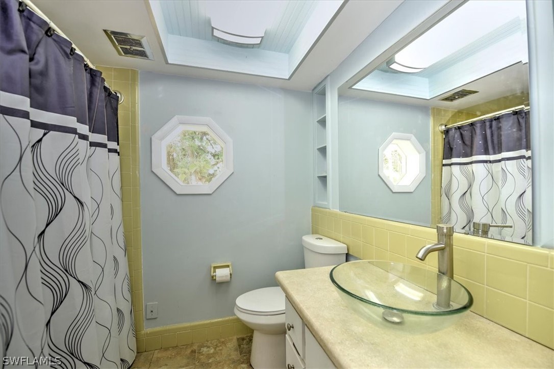 12271 Coyle Road Fort Myers, FL 33905 - Photo 20 of 33 a bathroom with a sink mirror vanity and toilet