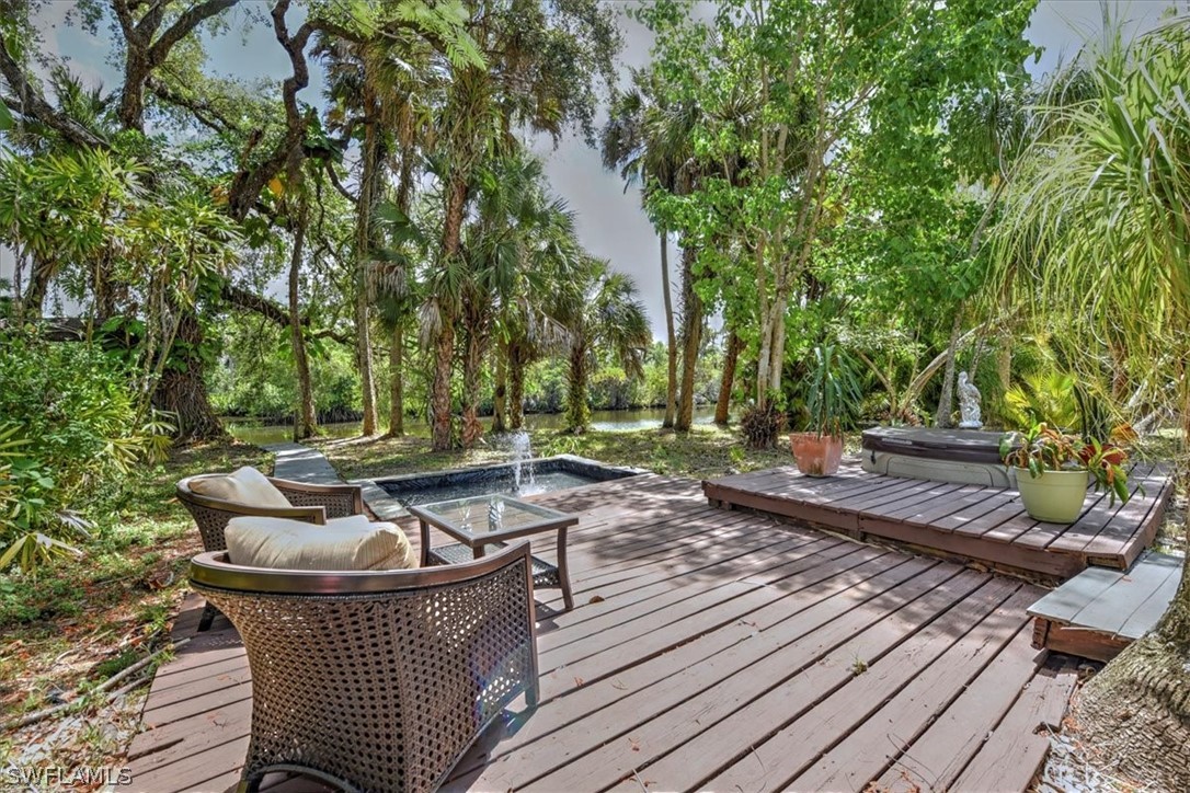12271 Coyle Road Fort Myers, FL 33905 - Photo 2 of 33 a view of a wooden chairs and fire pit in the backyard