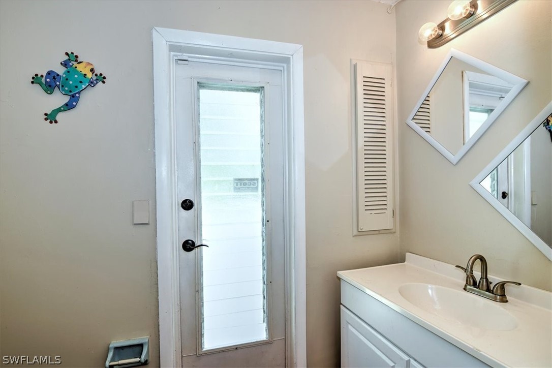 12271 Coyle Road Fort Myers, FL 33905 - Photo 22 of 33 a bathroom with a sink and a mirror