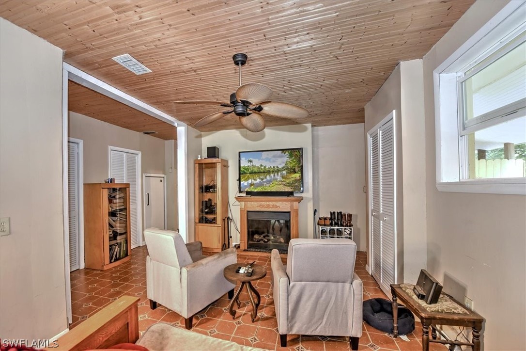 12271 Coyle Road Fort Myers, FL 33905 - Photo 24 of 33 a living room with furniture a fireplace and a flat screen tv