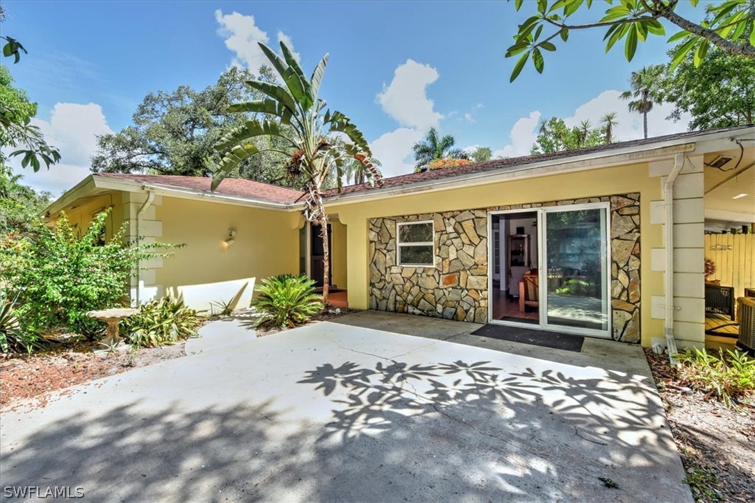 12271 Coyle Road Fort Myers, FL 33905 - Photo 3 of 33 a front view of a house with a garden