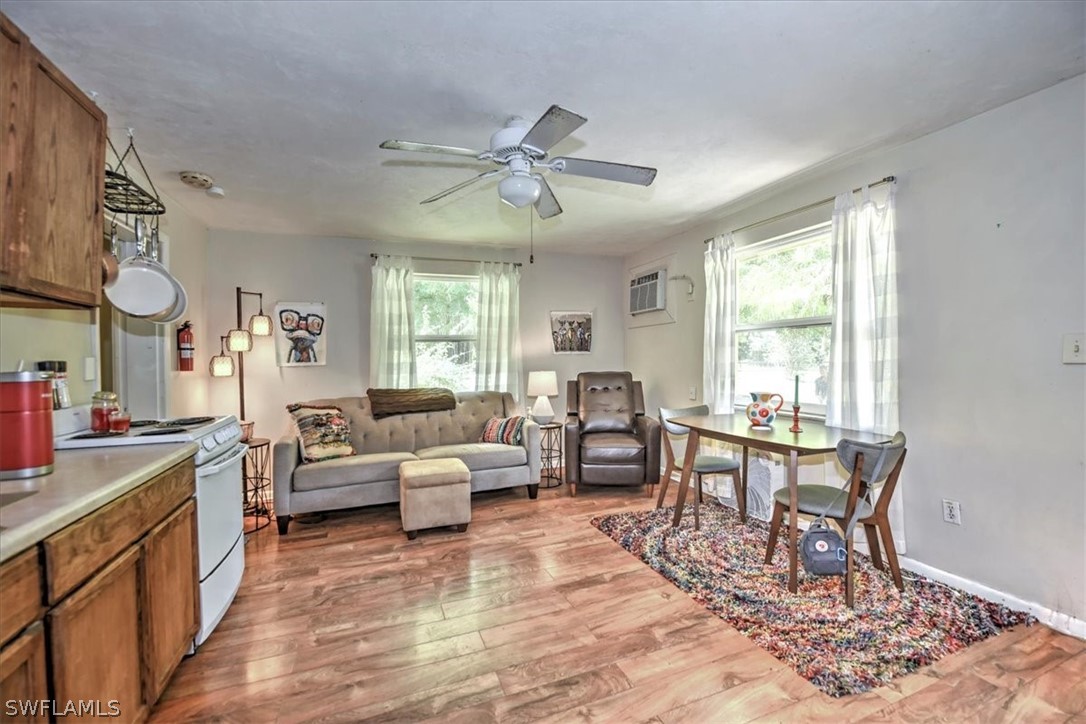 12271 Coyle Road Fort Myers, FL 33905 - Photo 32 of 33 a living room with furniture dining table and a large window