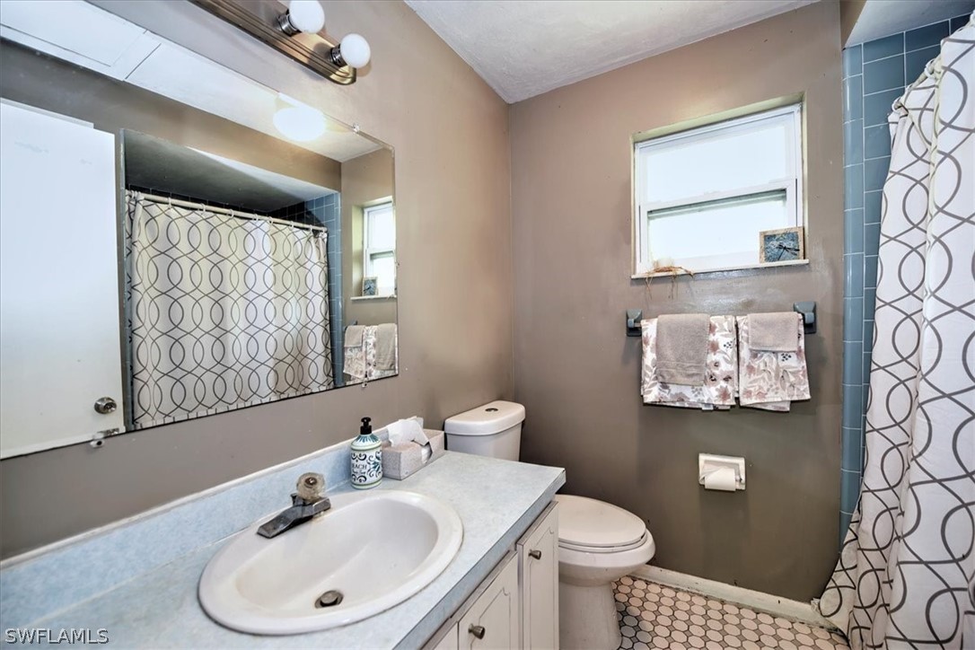 12271 Coyle Road Fort Myers, FL 33905 - Photo 33 of 33 a bathroom with a toilet sink and mirror