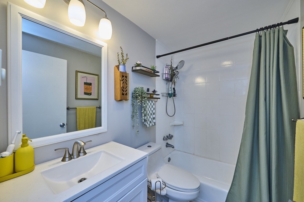 150 Wrentham Street, Unit 12 Boston, MA 02124 - Photo 12 of 12 a bathroom with a sink vanity granite toilet tub and shower