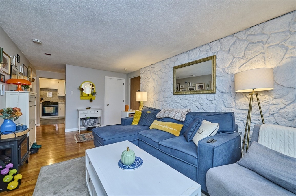 150 Wrentham Street, Unit 12 Boston, MA 02124 - Photo 4 of 12 a living room with furniture and wooden floor