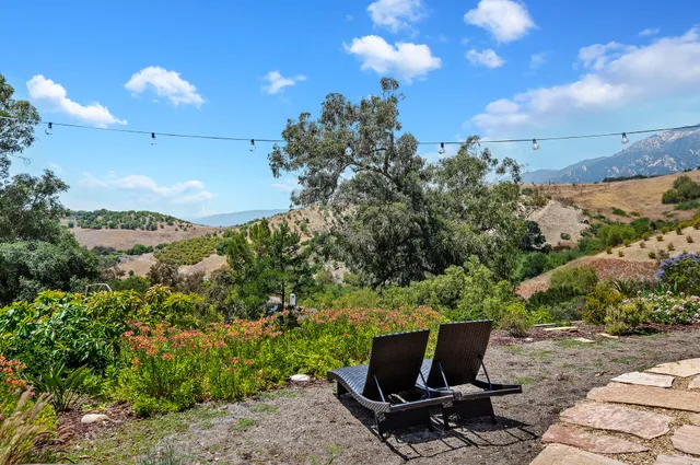 a view of a terrace with a garden and mountain view