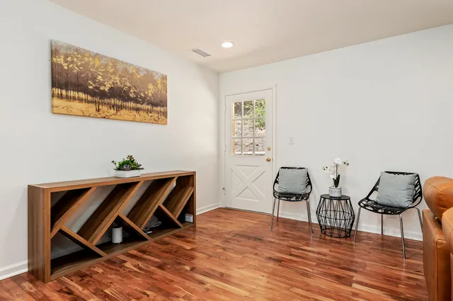 a view of a workspace with furniture and wooden floor