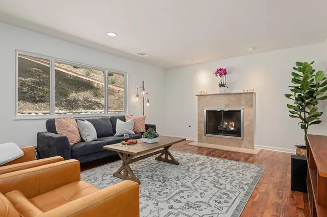 a living room with furniture and a fireplace