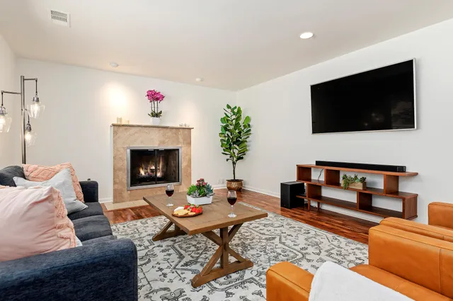 a living room with furniture and a fireplace