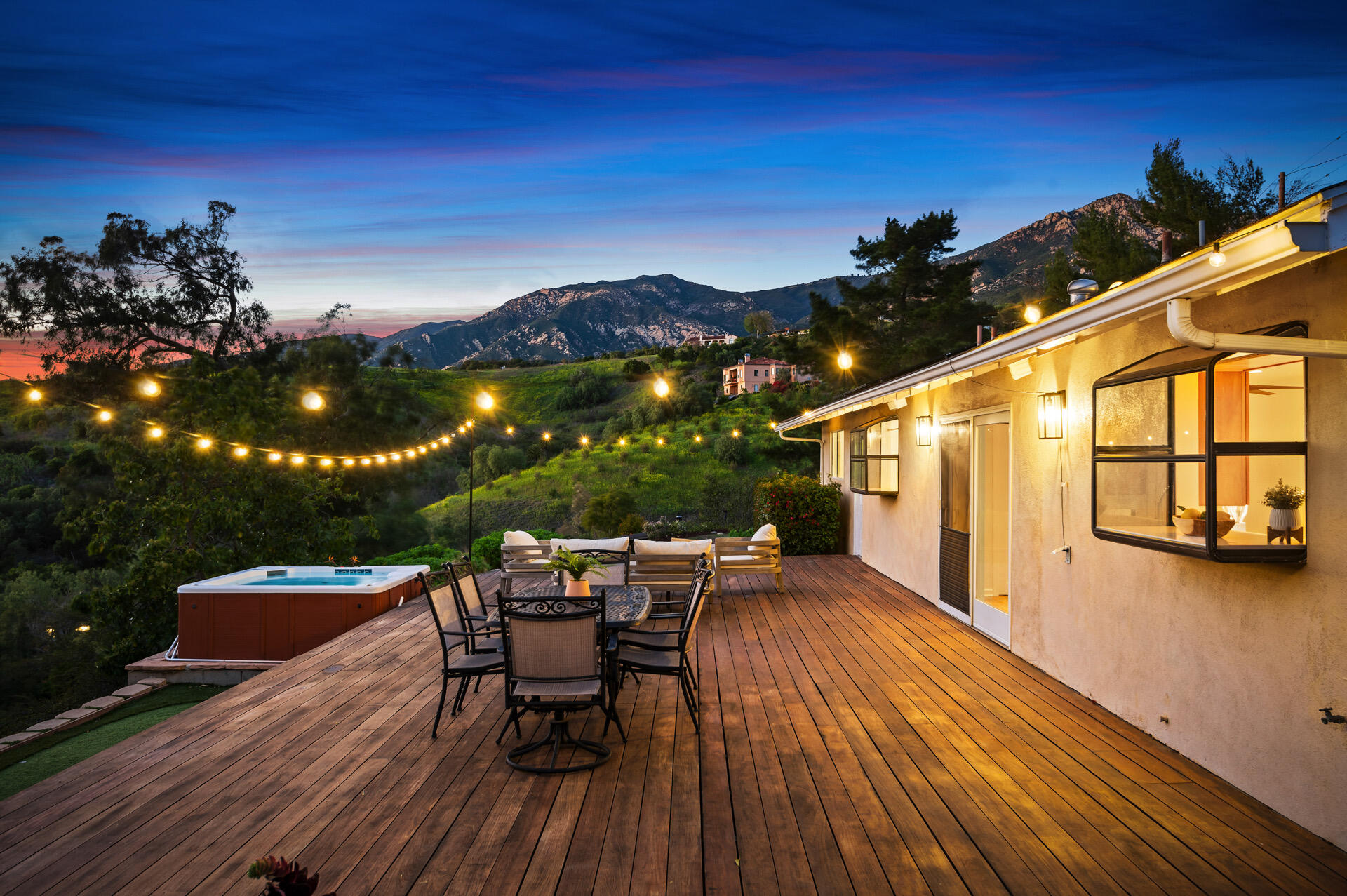 Undisclosed Address Santa Barbara, CA 93105 - Photo 2 of 30 a view of a patio with a table and chairs under an umbrella with wooden floor