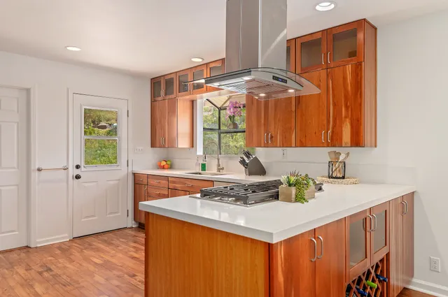 a kitchen that has a sink and a stove in it