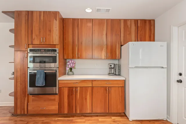 a kitchen with a refrigerator and a stove