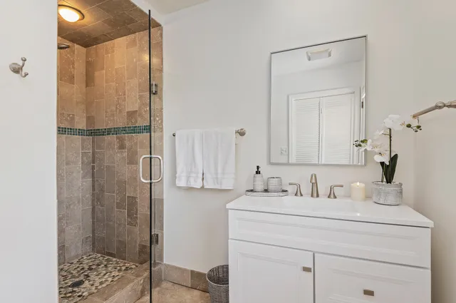 a bathroom with a sink a toilet and shower