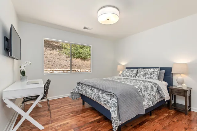a bedroom with a bed and a flat screen tv