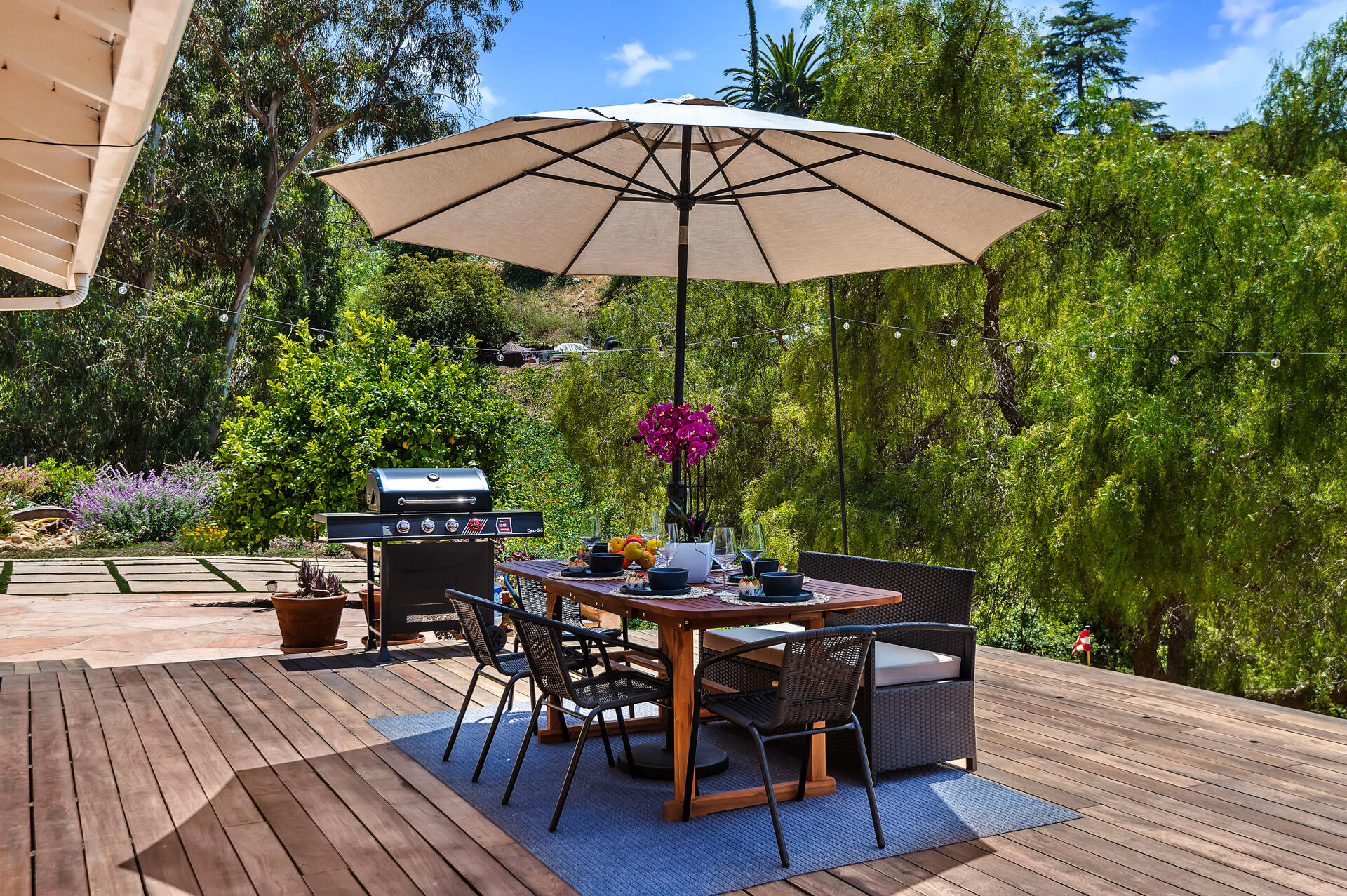 Undisclosed Address Santa Barbara, CA 93105 - Photo 5 of 30 a patio with wooden floor a yard a table and chairs
