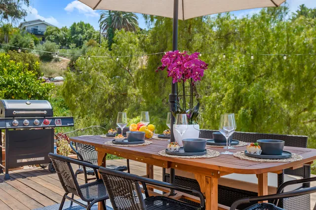 a view of a dining table and chairs in the patio