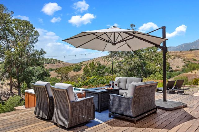 a view of a roof deck with furniture