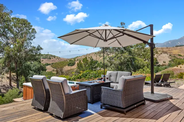 a view of a roof deck with furniture