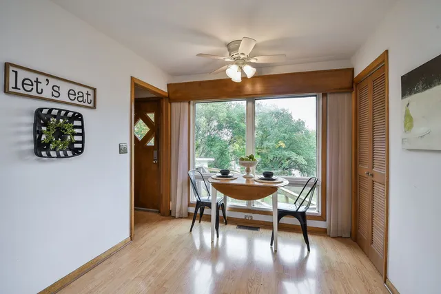 a dining room with a wooden table and chairs