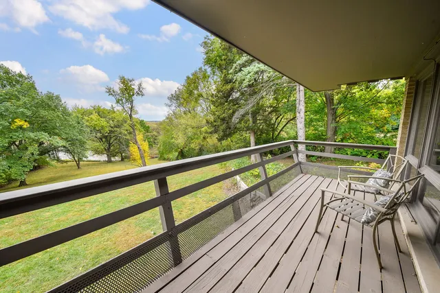 a view of balcony with wooden floor and outdoor seating
