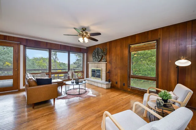a living room with furniture and floor to ceiling windows